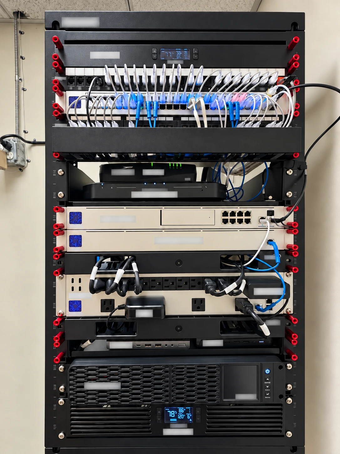 After: Baral IT network closet redesign with a labelled equipment rack, patch panels, power equipment, battery backup, and ventilation.